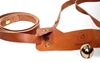Detail of a leather toy horse harness for children with brass snap fasteners and cheerful ringing copper bell.