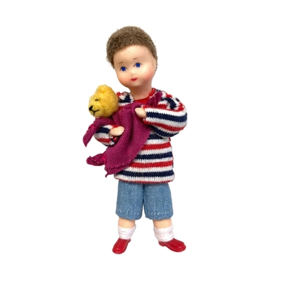 Doll for dollhouse, small boy with light blue trousers and red and blue striped hoody. He wears a Teddy bear in his arms and a purple cloth.
